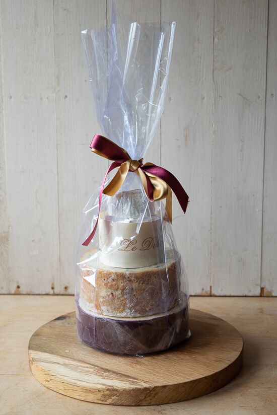 Cheddar & Stilton Cheese cake pre-wrapped in cellophane and decorated with ribbon