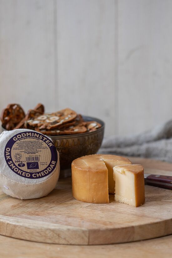 Godminster Oak Smoked cheddar on wooden cheese board