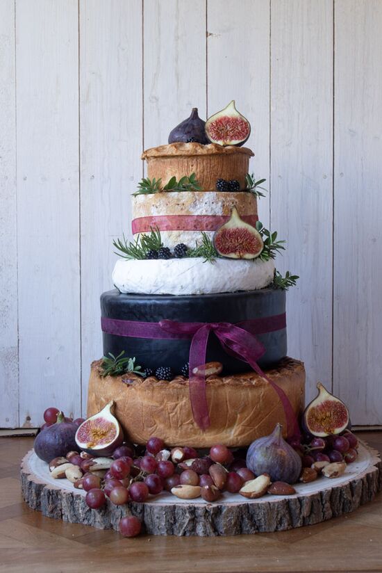 Cheese & Pork Pie Cake, with two pork pies and three cheeses decorated with burgundy organza ribbon