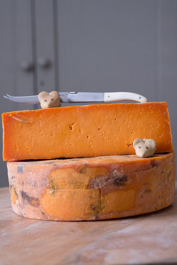 Rutland Red Leicester on cheese board with clay mice and cheese knife