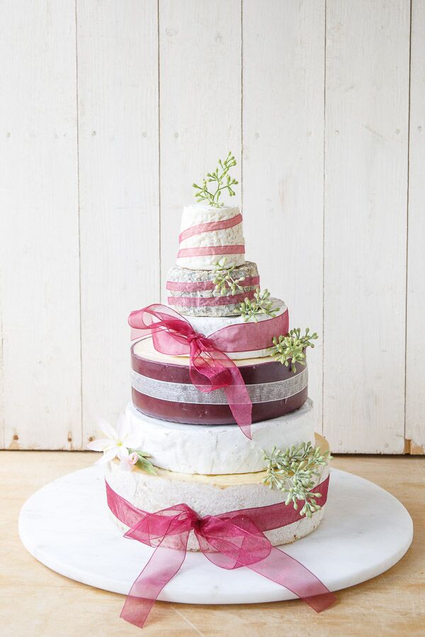 Wedding Cheese Cake or Celebration Cheese cake with 5 tiers of cheese, decorated with burgundy organza ribbon