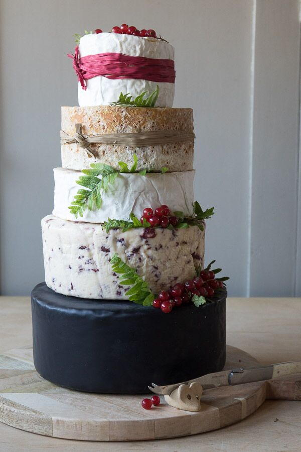 The gorgeous Berry cheese cake featuring 5 tiers of various cheeses including, black bomber,Wensleydale & crandberries, Elmhirst, Stilton and Somerset camembert. Decorated with red berries and red raffia.