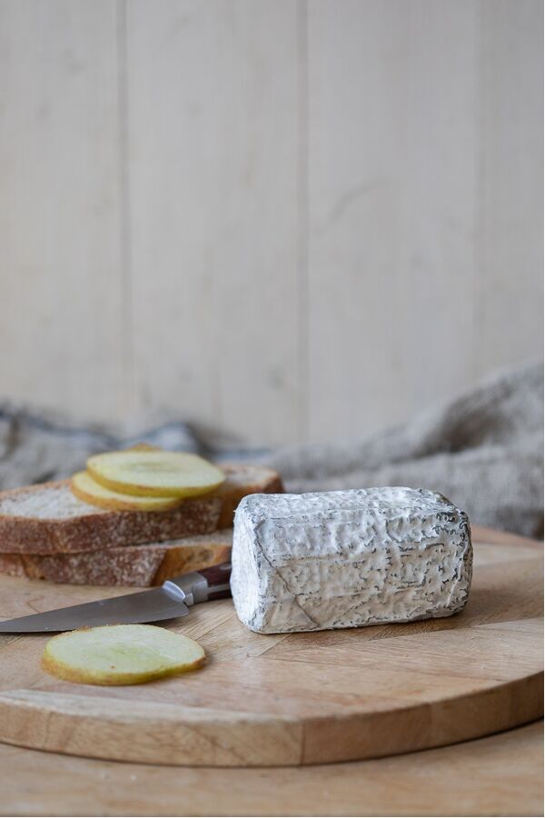 Driftwood goats cheese on wooden cheese board